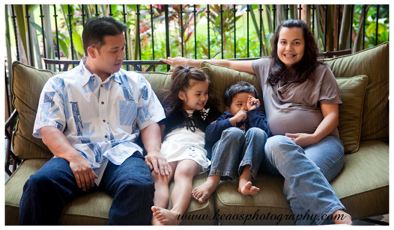 family sitting on couch laughing