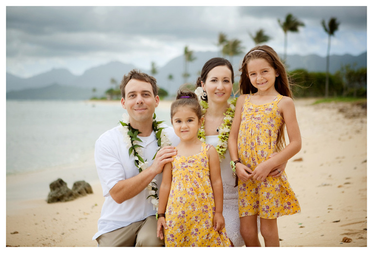 wedding photo of bride and groom with flower girls on Kualoa Beach