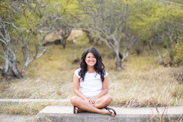 sweet sitting girl on a wall in Hawaii