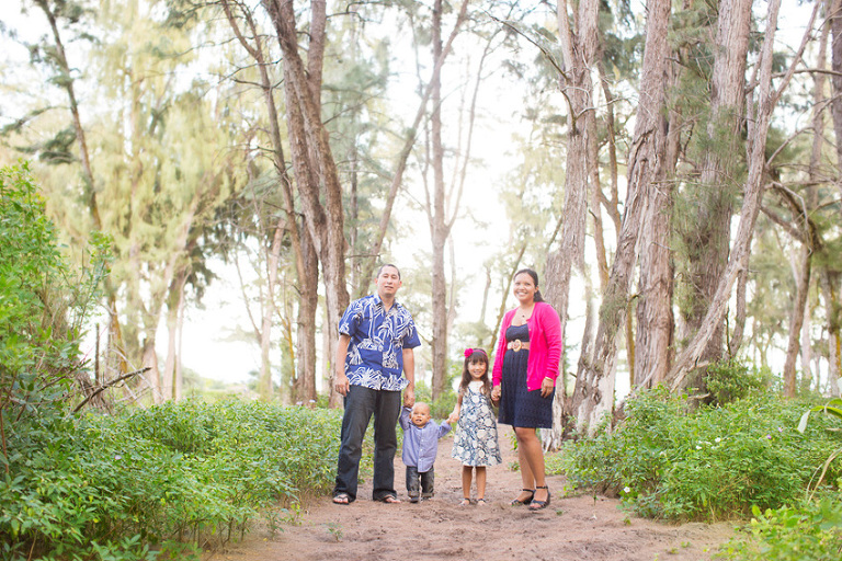 Oahu family posing for a family photo in woods