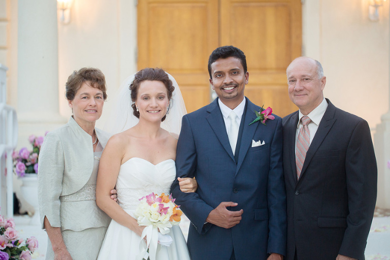 Happy couple with bride's parents after Hawaii wedding