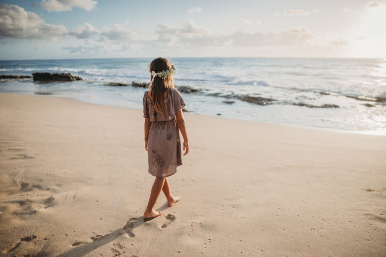 photo of a girl walking into the ocean