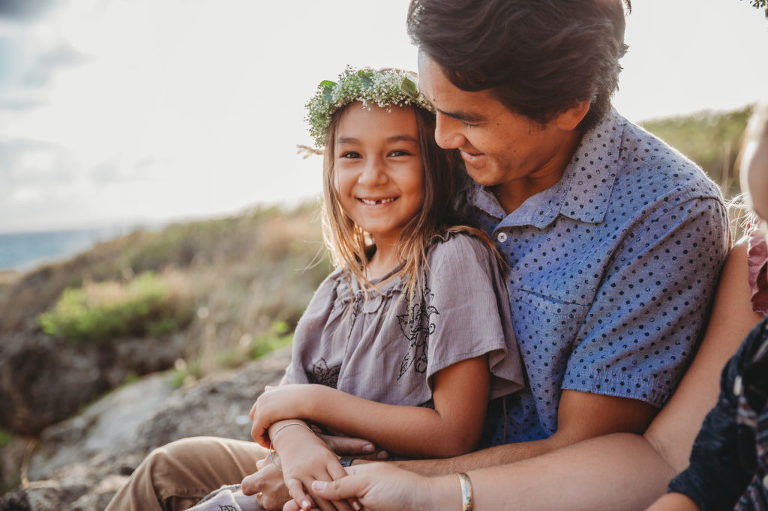 little girl with lei hugged by dad photo