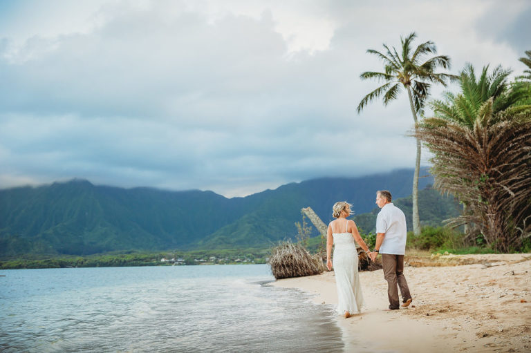romantic Hawaiian wedding couple on a beach at sunset