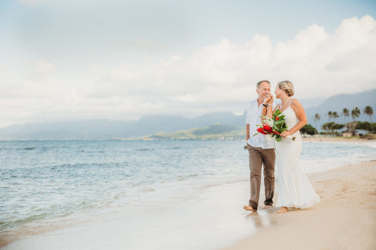 Wedding couple walking on Kualoa Beach up close