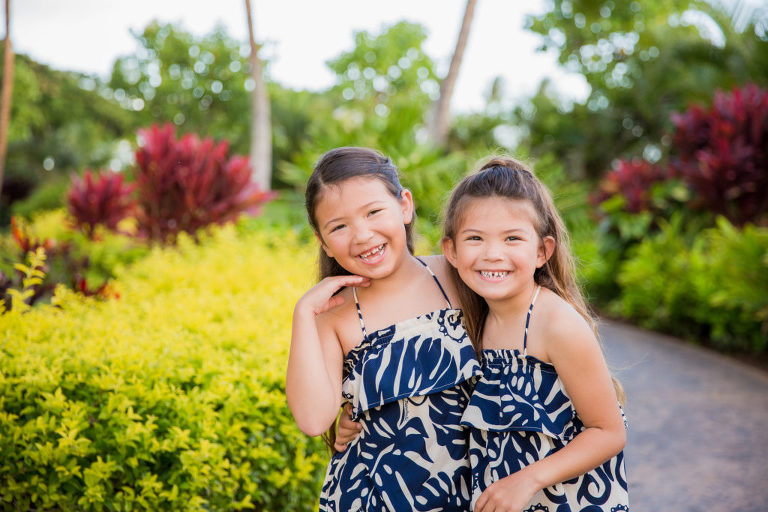 sisters laughing on path near Ko Olina hotel